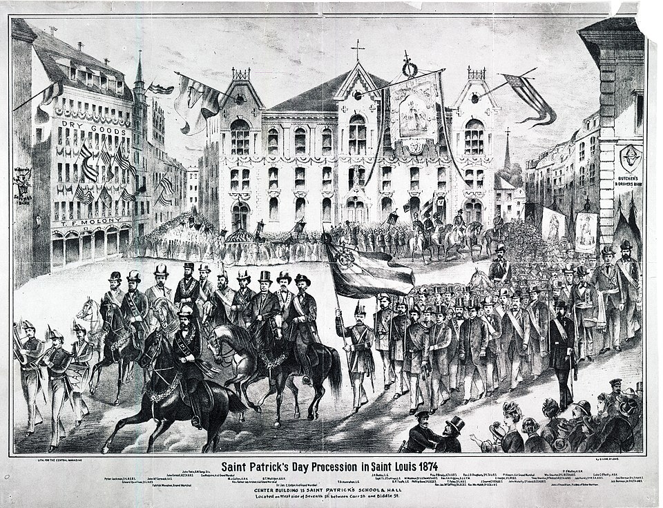 Horizontal lithograph showing a view of the 1874 Saint Patrick's Day procession in front of Saint Patrick's School and Hall, also includes T.F. Molony Dry Goods Building, Butcher's and Drover's Bank, and Hibernia Savins Bank.  Prominent persons are identified in the caption.Title: "St. Patrick's Day