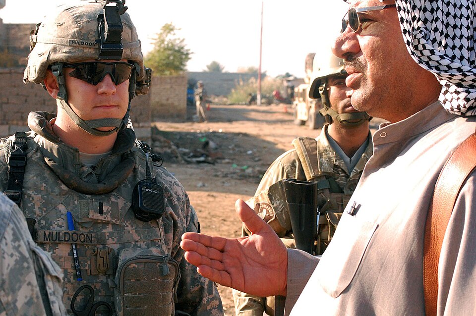 Lakeland, Tenn., native, 1st Lt. Patrick Muldoon, a platoon leader assigned to Battery A, 1st Battalion, 82nd Field Artillery Regiment, 1st Brigade Combat Team, 1st Cavalry Division, speaks to a local sheik during a knock and talk mission in Hor al-Bash, Dec. 11. Muldoon and the sheik discussed loca