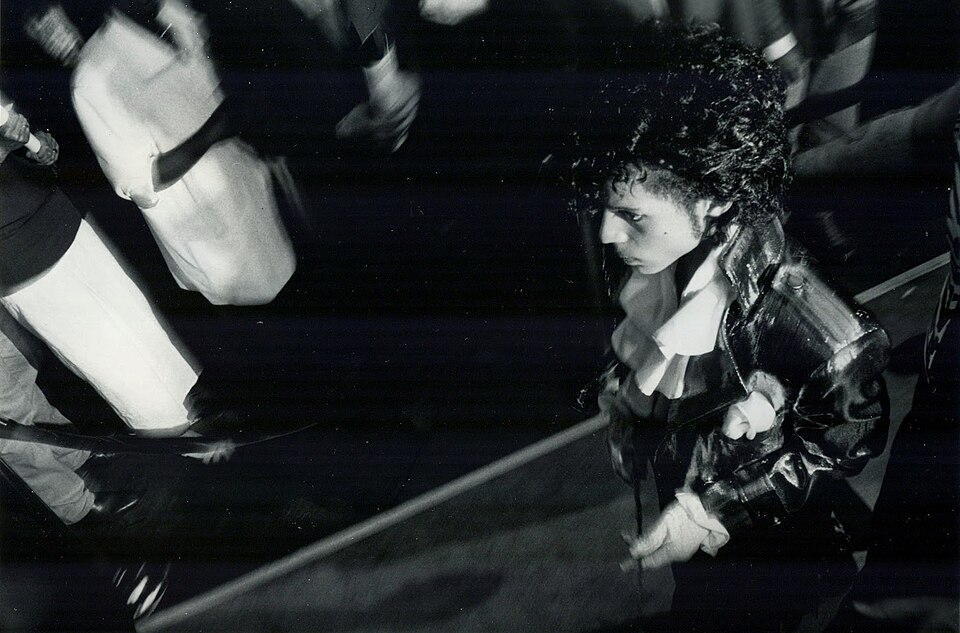 The American musician Prince in a press photo dated to 1984. No copyright markings on the photo and no registration could be found in the US Copyright Registry.