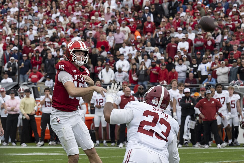 Fernando Mendoza, Indiana University quarterback, number 15, throws the football during the 2026 Rose Bowl at Pasadena, California, Jan. 1, 2026.  The Rose Bowl game, first played in 1902, represents more than a century of college football tradition and pageantry. A B-2 Spirit aircraft assigned to W