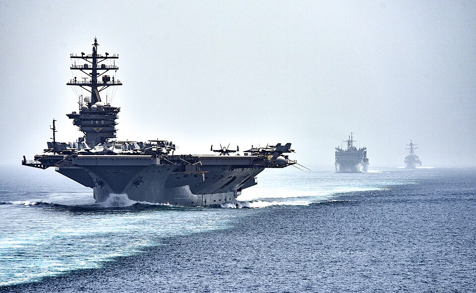 STRAIT OF HORMUZ (July 21, 2016) The aircraft carrier USS Dwight D. Eisenhower (CVN 69), followed by the fast combat support ship USNS Arctic (T-AOE 8) and the guided-missile destroyer USS Nitze (DDG 94), transit the Strait of Hormuz. The Eisenhower Carrier Strike Group is deployed in support of mar