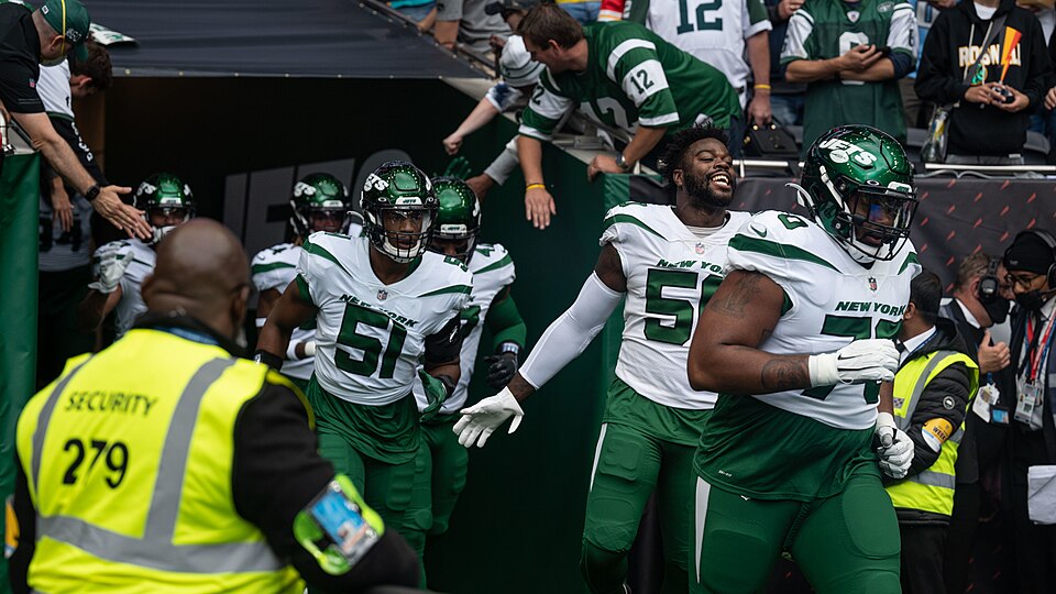 Players from the New York Jets enter the field at Tottenham Hotspur Stadium on Oct. 10, 2021. Airmen from the 48th Fighter Wing participated in honor guard duties and also organized a flyover for the event. (U.S. Air Force photo by Airman 1st Class Jacob Wood)