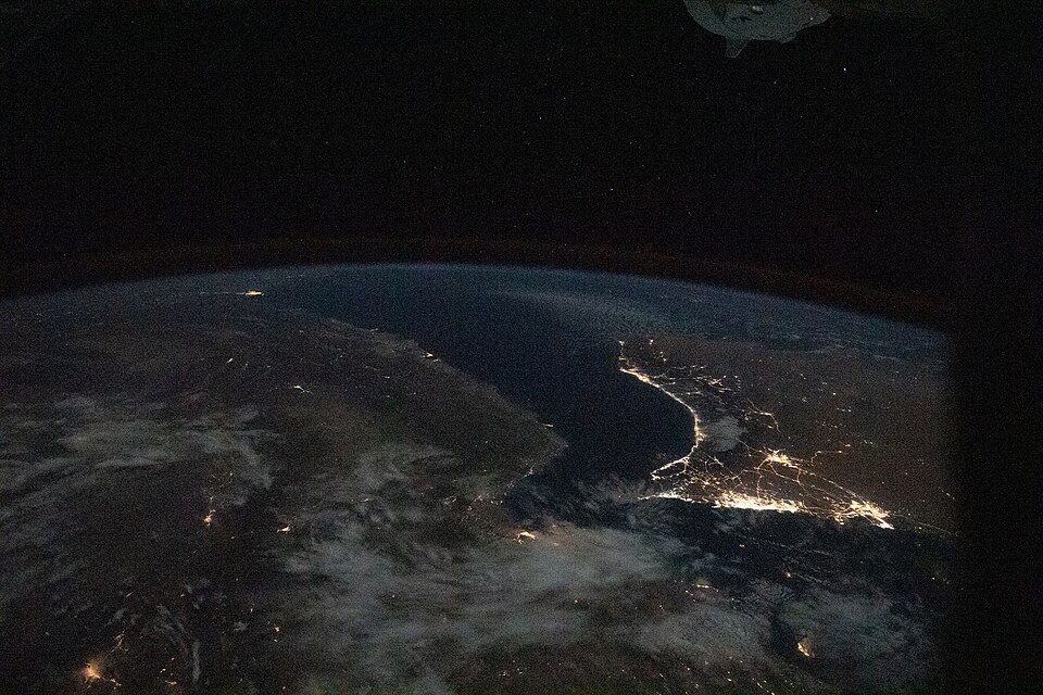 This image from International Space Station as it was flying 261 miles over Iran looks southeast across the Persian Gulf and the Gulf of Oman. The well-lit areas along the coast are cities located in the nations of Oman and the United Arab Emirates.