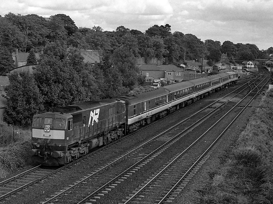 Derry line train leaving Lisburn - 1991With many 80-class DEMUs away on special workings for the Meath v Down GAA All-Ireland football final in Dublin, diesel locomotive haulage made a very rare appearance on passenger trains from Belfast to Londonderry (Waterside). Taking the now "mothballed" Lisbu