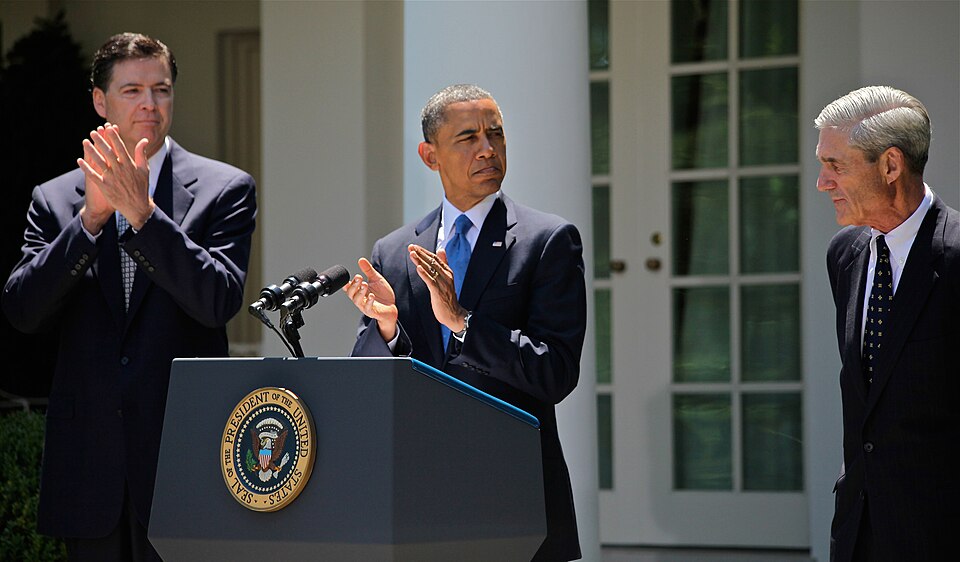 Former Deputy Attorney General James Comey (left), alongside President Barack Obama (center) and outgoing FBI Director Robert Mueller (right) at Comey's nomination to become the Seventh Director of the FBI.