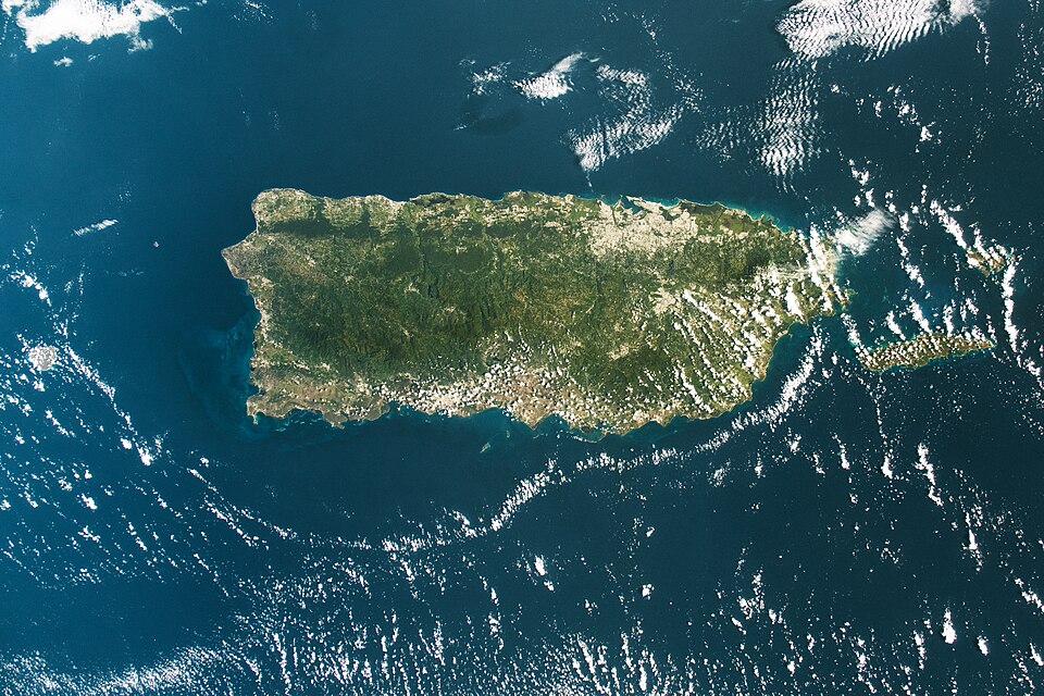 An astronaut aboard the International Space Station took these photos of Puerto Rico. The top image offers a wide view of the island, while the bottom image provides a detailed view of the San Juan metropolitan area. Puerto Rico is a Caribbean archipelago, consisting of the main island (Island of Pu