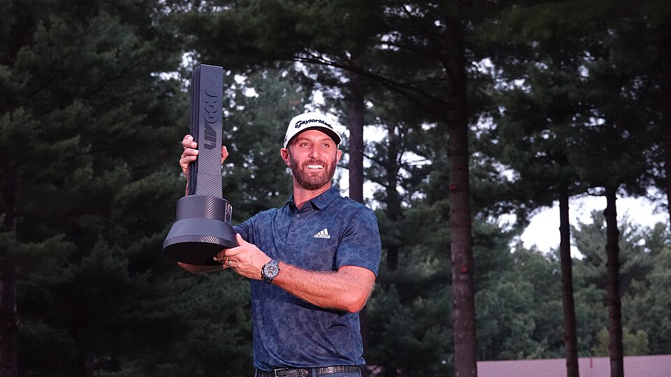 Dustin Johnson hoists the championship trophy following his victory in the LIV Golf Invitational Boston tournament.