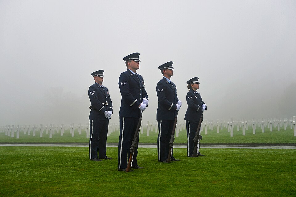Members of an Air Force honor guard team stand in formation during a Veterans Day ceremony at Henri-Chapelle American Cemetery and Memorial, Belgium, Nov. 11, 2017. The team conducted a three volley salute which historically signifies an end to hostilities for a period of time. The Airmen hailed fro