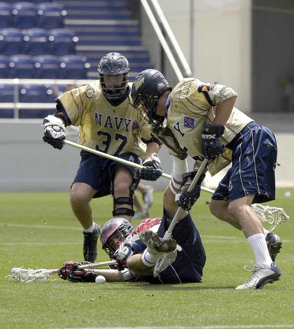 (original Navy caption):
University of Pennsylvania's P.J. Gilbert tries to fend off Midshipman 2nd Class Dan Harris, right, as Midshipman 1st Class Jared Bosanko comes in to assist during the first round action of the NCAA Lacrosse tournament. This is the first time since 1989 that the Navy (13-2),