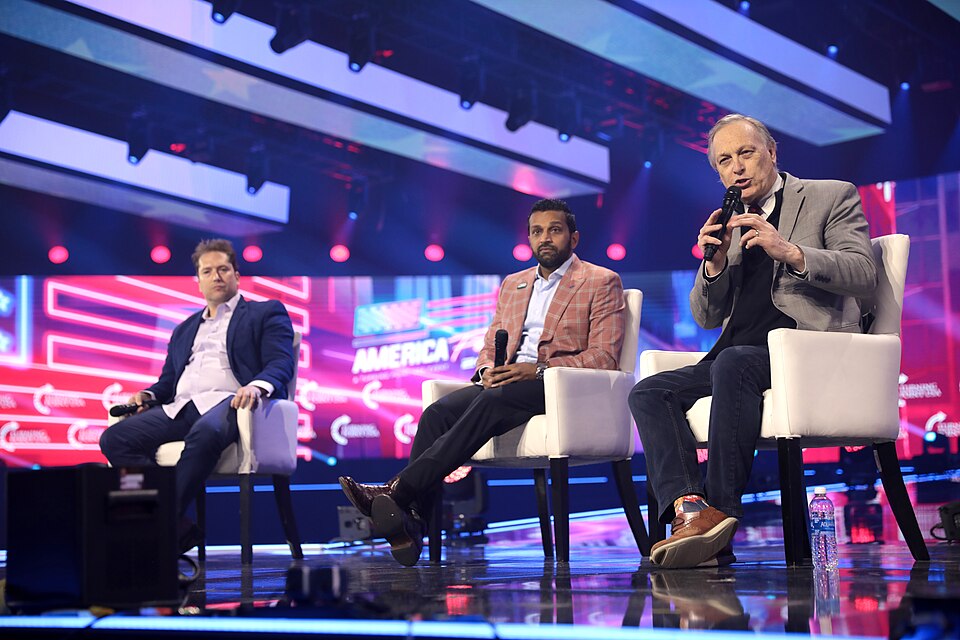 Darren Beattie, Kash Patel and U.S. Congressman Andy Biggs speaking with attendees at the 2022 AmericaFest at the Phoenix Convention Center in Phoenix, Arizona.