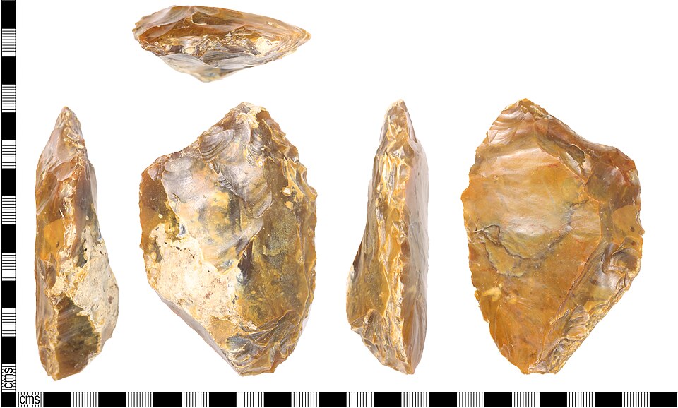 A large probable scraper of lower to middle Palaeolithic date, probably lat middle Palaeolithic c.60,000BC-40,000BC, which has been subsequently reworked and modified at a latter date.
Description: The tool has a wide curved scraper or crude chopper edge formed from short to invasive stepped semi-ab