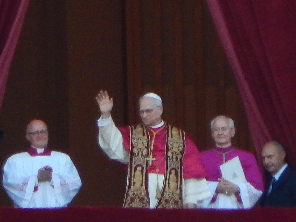 Pope Leo XIV waves at the people gathered in St. Peter's Square in his first public appearance as pope.