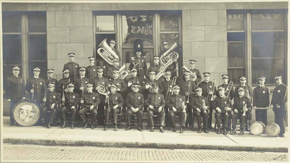 Seattle's Police Department Band started out by playing Sunday evening concerts at police headquarters. By the 1920s, they marched in city parades, played for city celebrations, played concerts in parks, and participated in funeral ceremonies for fallen comrades. 
This 1915 image shows the members o