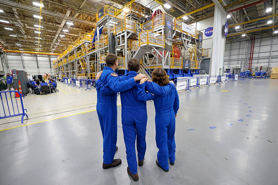 Artemis II NASA astronauts Reid Wiseman and Christina Koch of NASA and CSA (Canadian Space Agency) astronaut Jeremy Hansen view the core stage for the SLS (Space Launch System) rocket at the agency’s Michoud Assembly Facility in New Orleans on Nov. 16. The three astronauts, along with NASA’s Victor