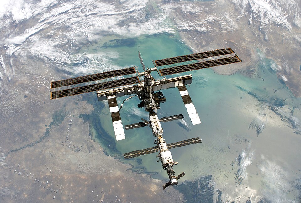 ISS photo taken from shuttle Discovery in August 2005. Original description: "Backdropped by a colorful Earth, this full view of the International Space Station was photographed from the Space Shuttle Discovery during the STS-114 Return to Flight mission, following the undocking of the two spacecraf