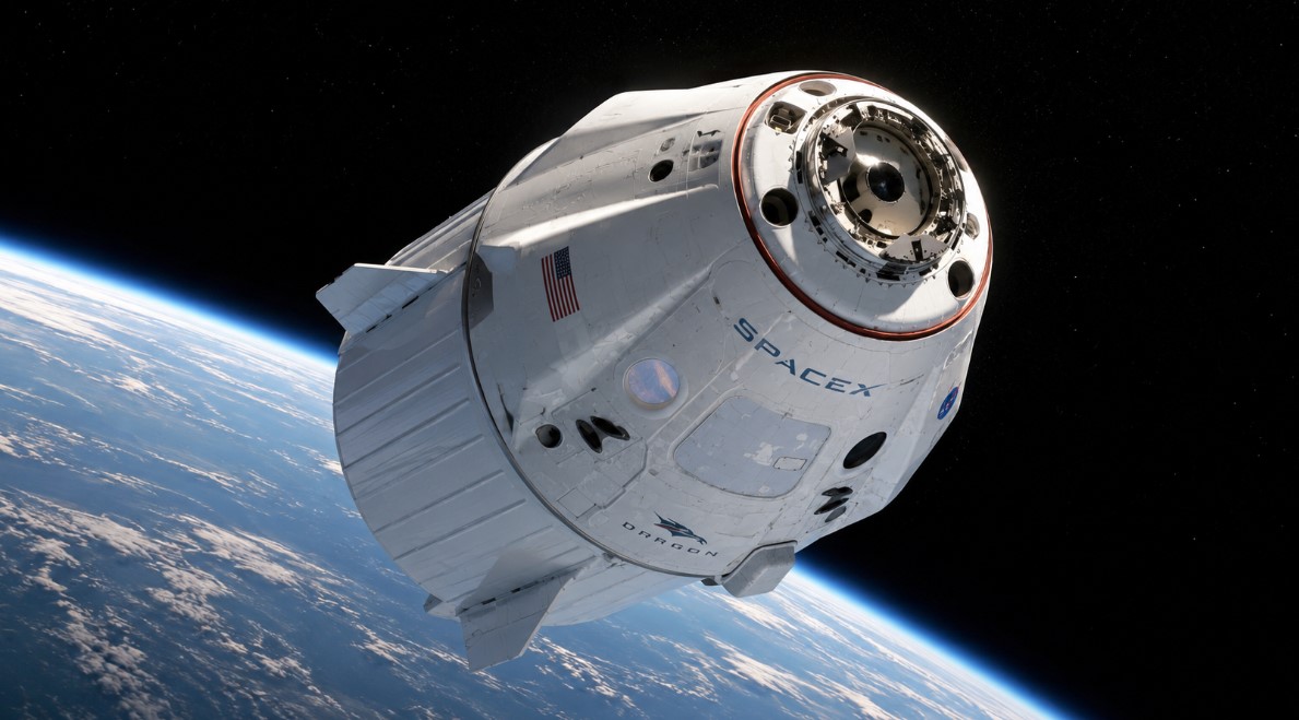 A wide space illustration shows a SpaceX Dragon-style spacecraft orbiting above Earth with the planet’s curved horizon glowing against deep black space.