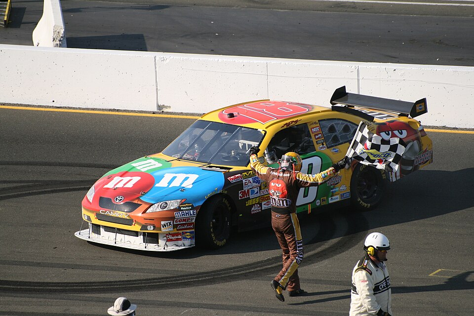 Kyle Busch on his way back to his car after he takes the checkered flag.
