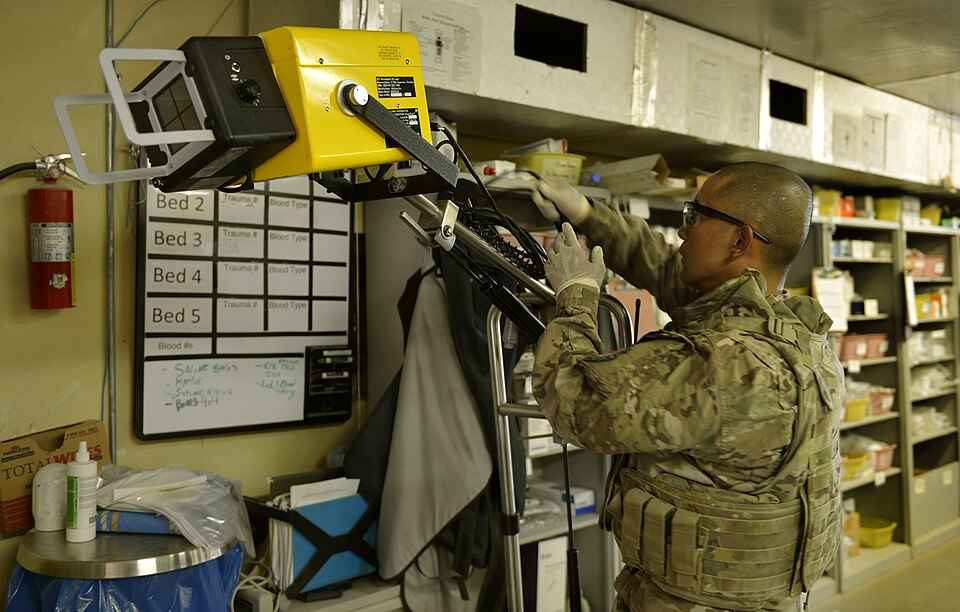 Master Sgt. Ovendalin Brown, Forward Surgical Team medical technician, sets up X-ray equipment in the emergency room on Forward Operating Base Ghazni, Aug. 25, 2013. When Brown is not in the ER treating patients, he is in charge of the 24-airman team. Brown is deployed from Luke Air Force Base, Ariz