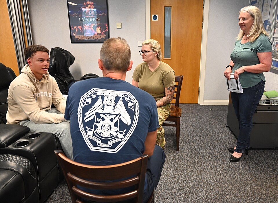 U.S. Air Force Airmen and British civilians from the 100th Civil Engineer Squadron Fire Department and 100th Security Forces Squadron interact during a role play session during a Mental Health First Aider course as Maj. Pauline Murray-Knight MBE, right, MHFA national trainer, listens to their respon