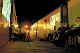 Delta block residents at Cuzco barracks engage in two separate multi-player video game sessions projected against barracks walls late Saturday evening. – JTF Guantanamo photo by Army Sgt. 1st Class Vaughn R. Larson