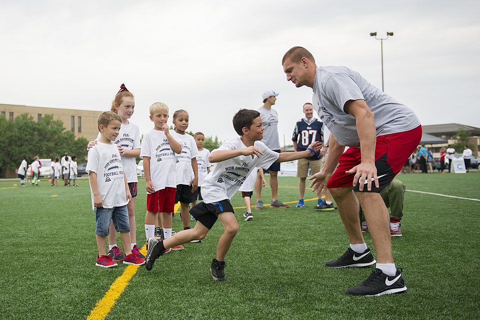 Rob Gronkowski, New England Patriots tight end, runs football drills with participants of a ProCamps event on Joint Base Andrews, Md., July 2, 2015. Gronkowski, a three-time Pro Bowler and Super Bowl XLIX champion, coached approximately 100 military children during the two-day football camp. (U.S. A