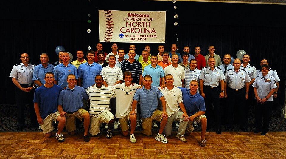OFFUTT AIR FORCE BASE Neb.,-- Baseball Players from the University of North Carolina, take a team photo with 55th Wing Leadership as part of a base tour where members of the Tar heels got an inside look at the mission of the 55th Wing, 15 June.  The Tar Heels baseball team is competing in the NCAA C