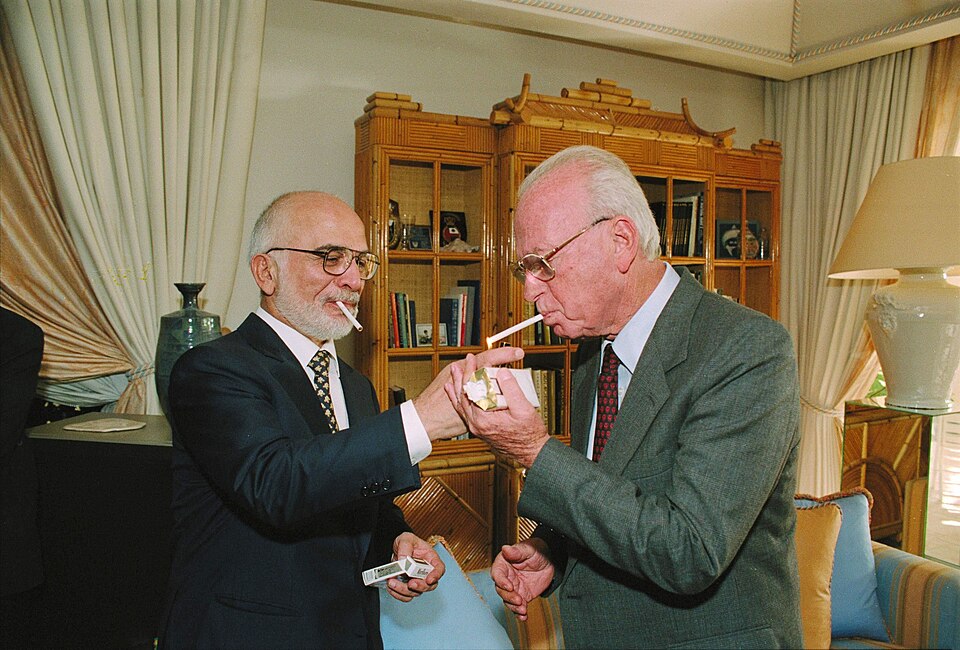 King Hussein of Jordan lights Israeli Prime Minister Yitzhak Rabin's cigarette at his royal residence in Akaba, shortly after signing the peace treaty at Arava border-crossing.
