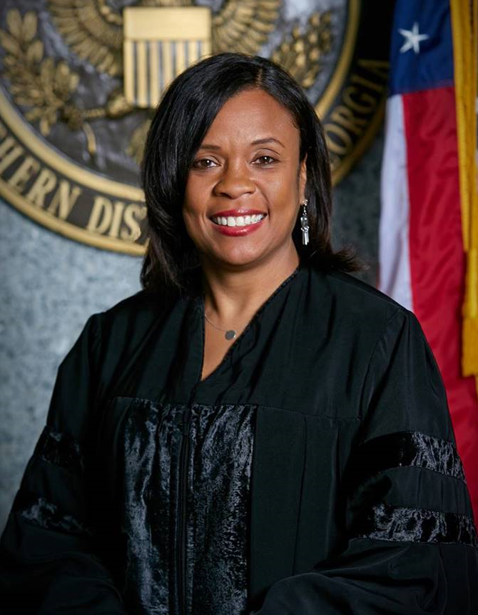 Judge Ross in robe with official seal