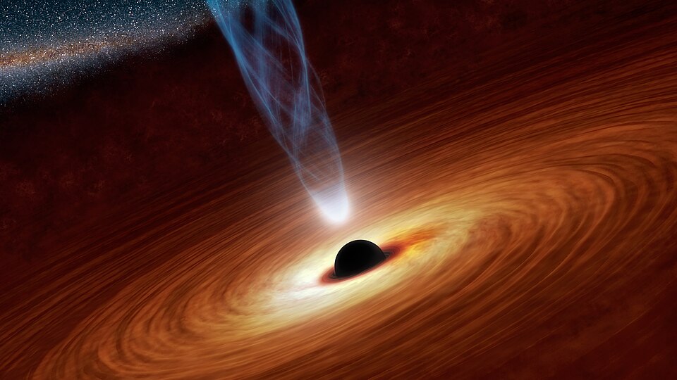 This artist's concept illustrates a supermassive black hole with millions to billions times the mass of our sun. Supermassive black holes are enormously dense objects buried at the hearts of galaxies. (Smaller black holes also exist throughout galaxies.) In this illustration, the supermassive black