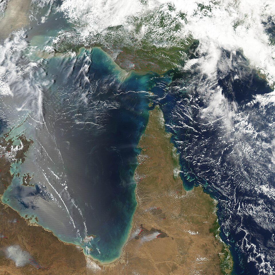 In early October, fires (marked in red) were burning across northern Australia (bottom) and New Guinea (top). This Moderate Resolution Imaging Spectroradiometer (MODIS) image from the Aqua satellite on October 4, 2004, shows several large, intense fires across the grasslands and savannas of the Cape