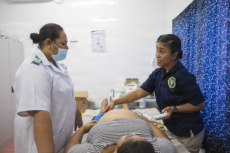 FALEOLO, Samoa (Oct. 27, 2025) – Cmdr. Cheryl Castro, right, and Shalon Talalelei-Mulipola, registered nurse midwife, left, perform a prenatal checkup on a Samoa local at Faleolo Medical Center, in Faleolo Medical Center at Faleolo, Samoa, in support of Pacific Partnership 2025, Oct. 27. Now, in its