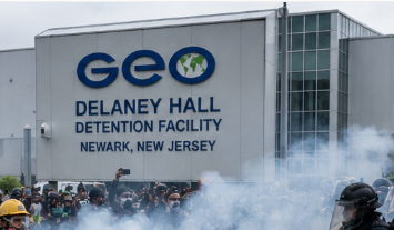 Protesters and riot police clash outside Delaney Hall detention facility in Newark, New Jersey, during demonstrations over immigration detention conditions.