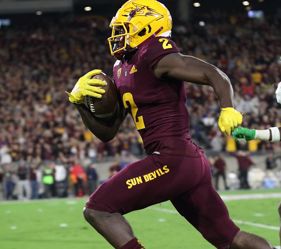 ASU #2 Brandon Aiyuk racing down the sidelines to the endzone'