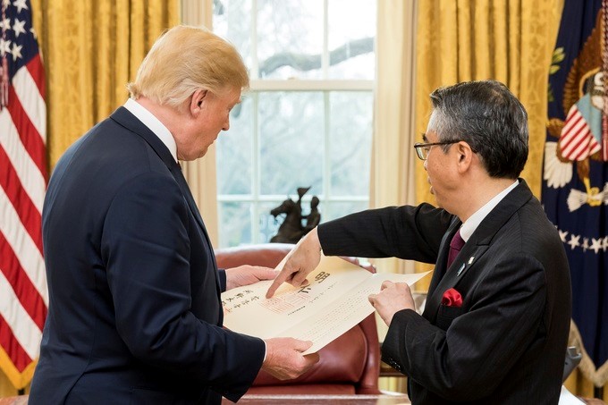 President Donald J. Trump is shown the ceremonial credentials from the newly appointed Japan Ambassador to the United States, Shinsuke Sugiyama, in the Oval Office at the White House, Wednesday, March 28, 2018, in Washington, D.C.