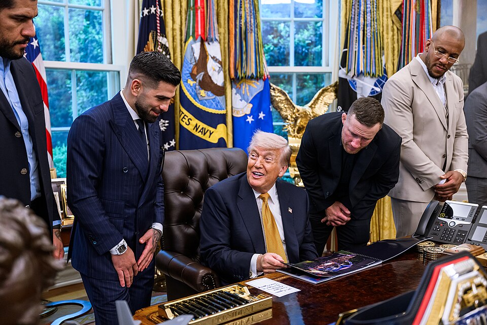 Donald J. Trump speaks with members of the media alongside UFC fighters