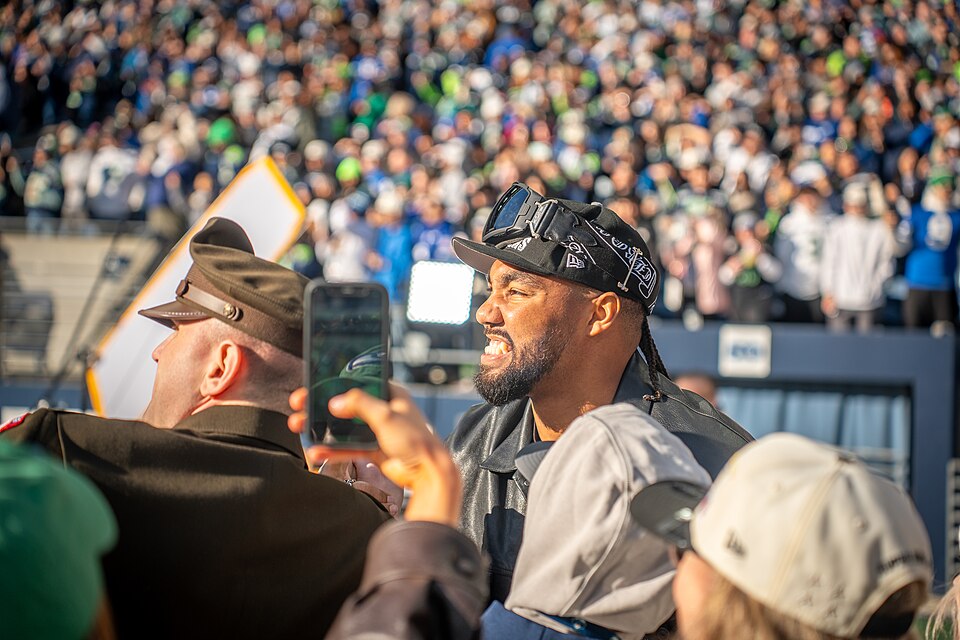 Seattle Seahawks defensive end, Leonard Williams, takes photos with the fans at the Super Bowl LX parade. Photo By Spc. Ryan Dunn