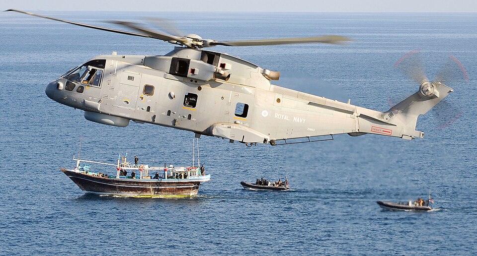 A Royal Navy Merlin helicopter provides cover for Royal Marines from Fleet Protection Group Royal Marines(FPGRM) as they board a suspicious dhow.  
On 25th May 09 HMS CUMBERLAND deployed from Devonport to the Gulf of Aden and Horn of Africa region as part of the United Kingdom's contribution to mari