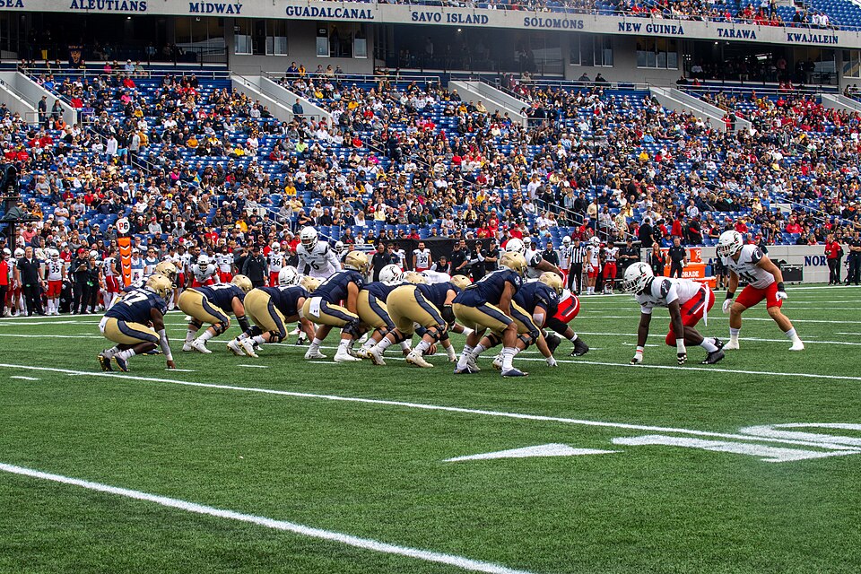 ANNAPOLIS, Md. (Oct. 23, 2021) The United States Naval Academy Midshipmen play football against the Cincinnati Bearcats at Navy-Marine Corps Memorial Stadium.Navy Midshipmen on offense. (U.S. Navy Photo by Mass Communication Specialist 3rd Class Thomas Bonaparte Jr./Released)