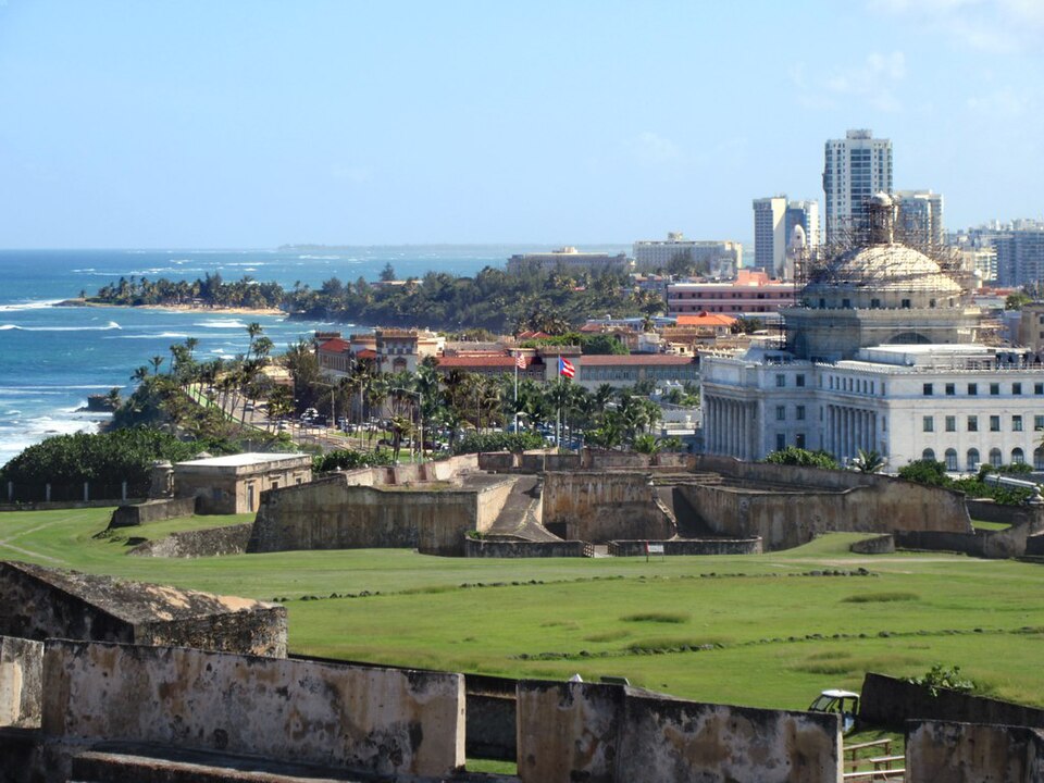 The Castillo San Cristobal (foreground) was intended to protect colonial San Juan from land attack. The white domed building beyond is El Capitolio (1929), seat of Puerto Rico's Legislative Assembly.