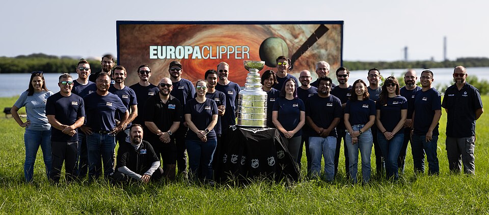 Earlier this year, the Florida Panthers won their first NHL championship and brought victory to the state of Florida. As part of its championship tour, the Stanley Cup made a visit to NASA’s Kennedy Space Center. Here, members of NASA’s Europa Clipper team pose with the National Hockey League’s Stan