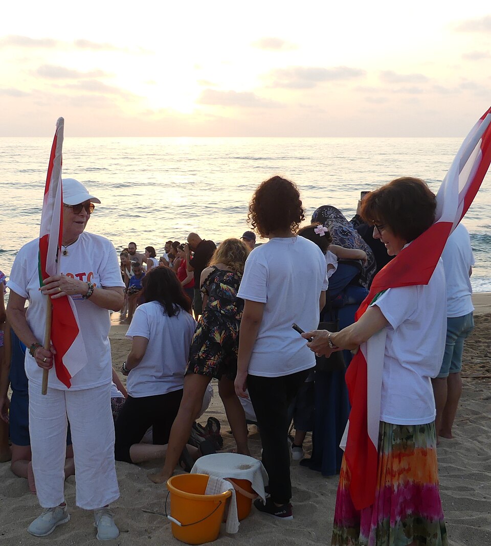 Lebanese environmentalist Mona Khalil, co-founder of the Orange House project to protect endangered sea turtles, and her associate Habiba Fayed (sometimes spelled Syed) on Mansouri beach, about 6 km south of the city of Tyre/Sour, after releasing hatchlings into the Mediterranean Sea.