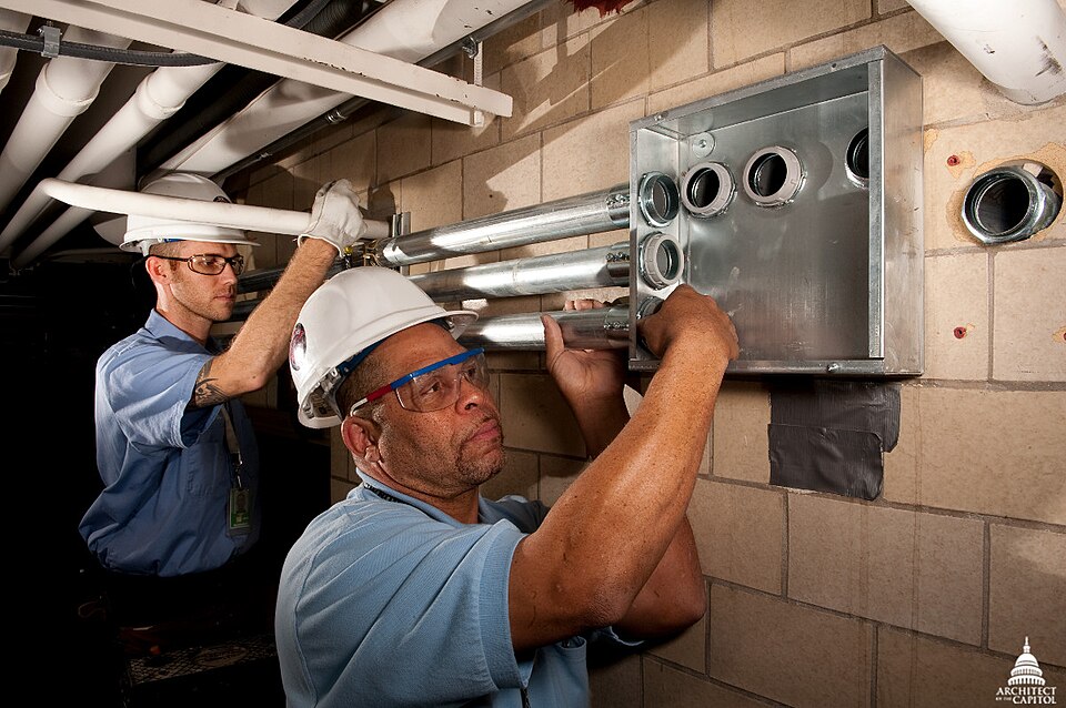 AOC pipefitters intalling fire supression systems inside the Library of Congress.This official Architect of the Capitol photograph is being made available for educational, scholarly, news or personal purposes (not advertising or any other commercial use). When any of these images is used the phot