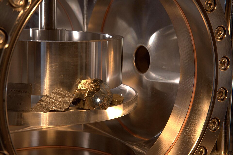 This image from testing of ChemCam shows a ball of luminous plasma erupting from the surface of an iron pyrite crystal in the sample chamber approximately 10 feet from the instrument. The laser beam itself is invisible.
The ChemCam instrument, built for NASA's Mars Science Laboratory mission, uses a
