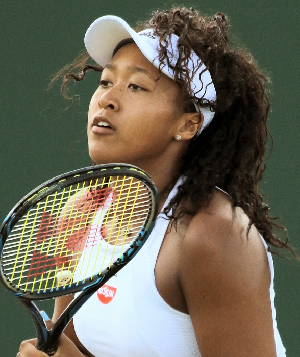 A photo of tennis player Naomi Osaka playing at Wimbledon in 2017.