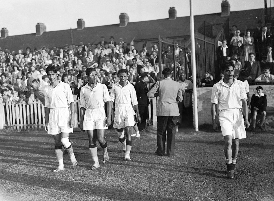 Talimeren Ao on the left, leading the Indian team to Cricklefield Stadium to play against France, on 31st July 1948. 8 players out of 11 played barefoot but 3 players wore boots though the weather was dry.