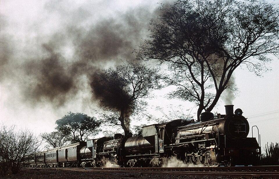 South African class 19D 4-8-2 locomotives nos. 3323 &amp; 3334 (both built by the North British Locomotive Company in 1948) run past in the late evening near Groenbult, South Africa, with the "Union Limited Zambezi" train organised by the Transnet Museum.