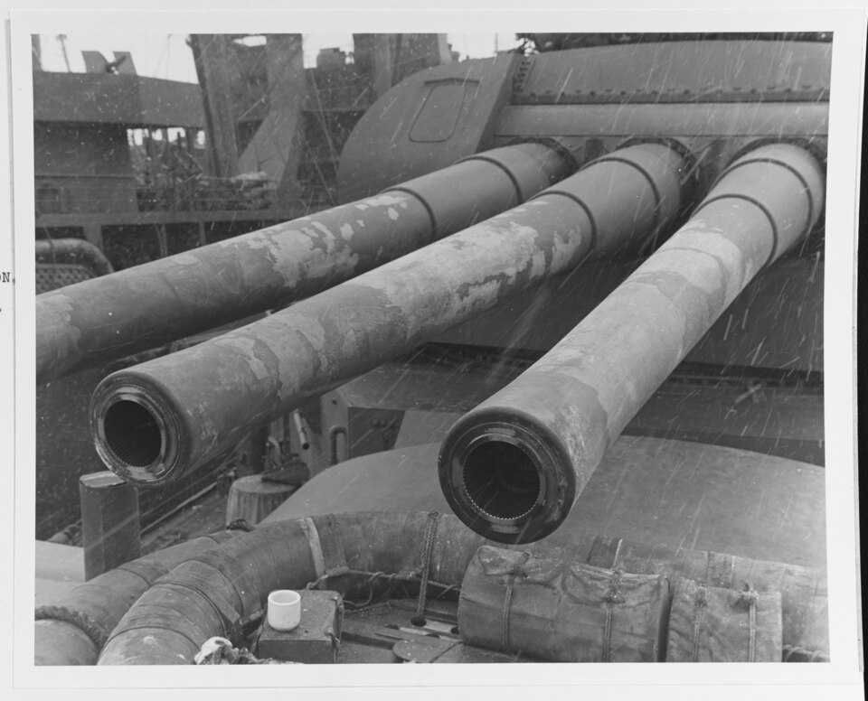 8"/55 guns of turret #3, USS Salt Lake City (CA-25), showing heat scale on the tubes from extensive firing during the action, taken after the battle of the Komandorski Islands at Dutch Harbor, 30 March 1943. Note snow flakes falling.