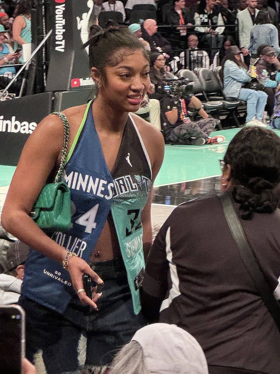 Angel Reese as a spectator at the 2024 WNBA Finals Game 5, New York Liberty vs Minneapolis Lynx, wearing a custom Napheesa Collier/Breanna Stewart Jersey.