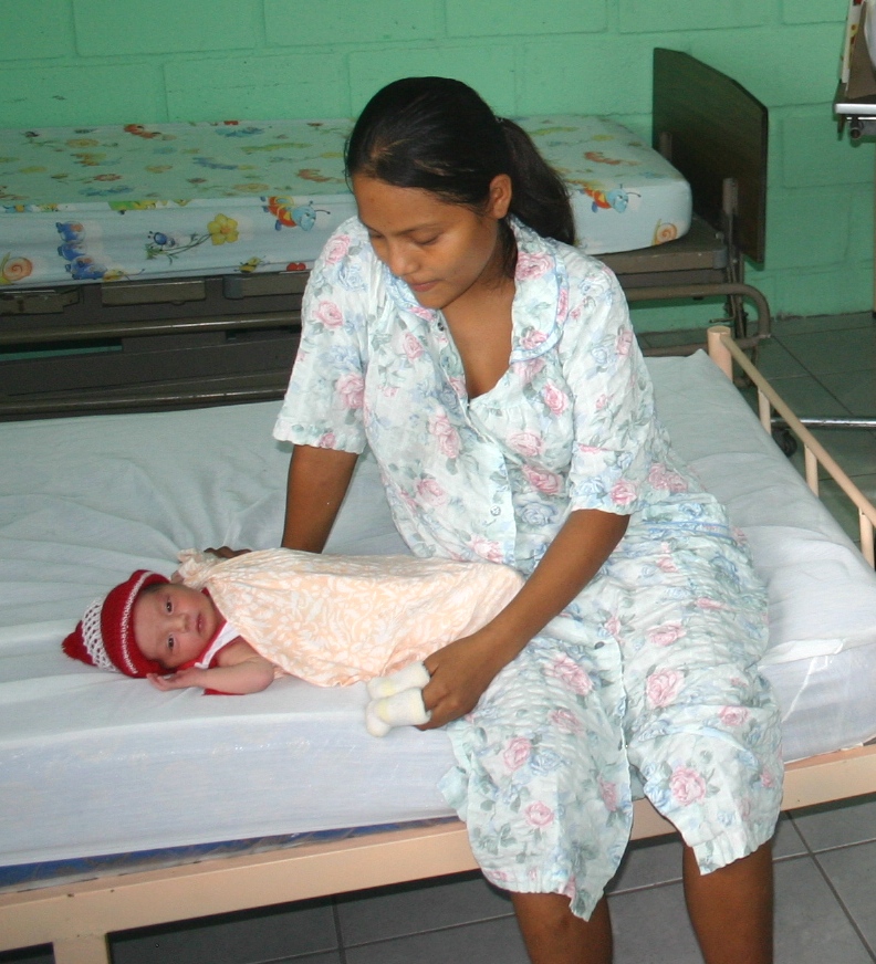Honduras: Local Clinics Improve Health Services  
A mother and child in a clinic in Taulabé, Honduras. 

For the past five years, USAID has helped local governments in Copán take over the management of area health care systems through a process called decentralization, which transfers health care ma