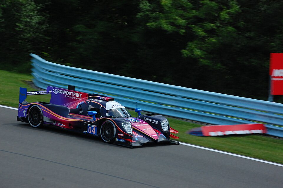 Oreca 07 of CrowdStrike Racing by APR, driven by George Kurtz, Toby Sowery, and Malthe Jakobsen, enters turn seven during the 2025 Sahlen's Six Hours of the Glen weekend at Watkins Glen International.